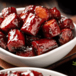 Hot Dog Burnt Ends coated in mustard and BBQ rub on tray-tasty