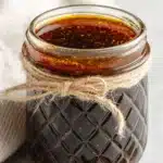 Hibachi Steak Marinade 2 tasty Raw flank in hibachi steak marinade in a glass container.