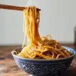 Hibachi Noodles Recipe 2 Hibachi noodles served with chicken, shrimp, and vegetables on a full dinner plate.