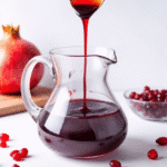 Pomegranate syrup drizzled over Greek yogurt and berries