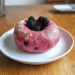 Blackberry Sourdough Bagels dough being folded with fresh blackberries