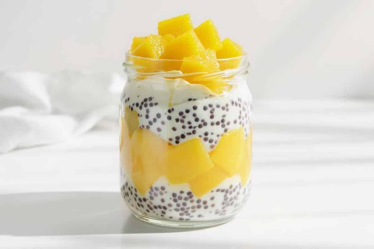 jar of mango chia seed pudding topped with coconut